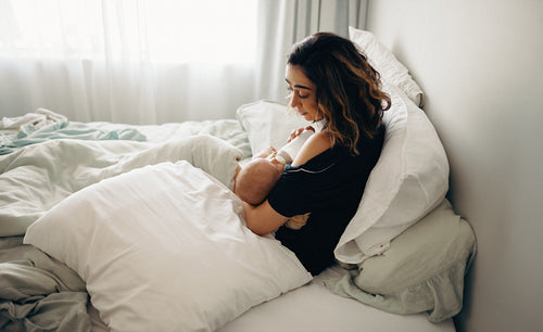 Mother bottle-feeding newborn baby