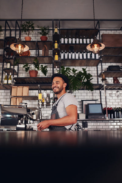 Young business owner standing in a cafe