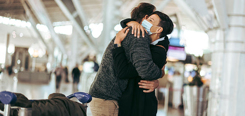Woman welcoming her husband arriving from abroad