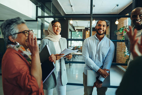Cheerful businesspeople laughing happily during a meeting