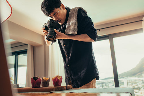 Food photographer taking pictures of cupcakes