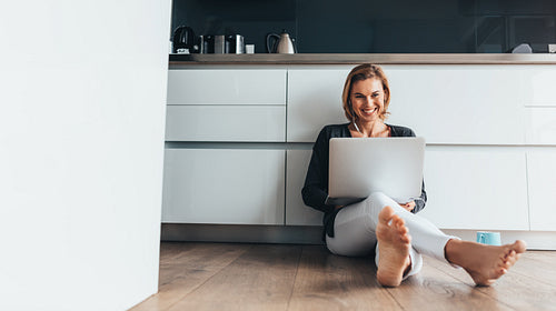 Woman working on laptop computer at home