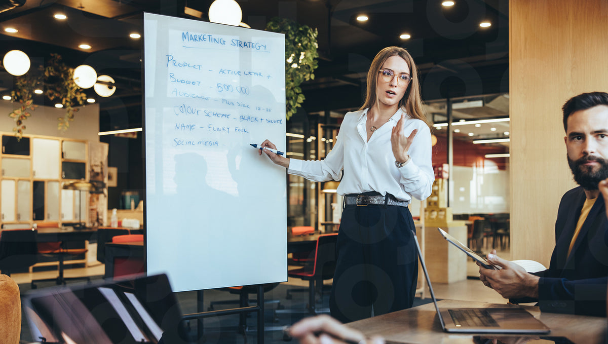 Manager discussing her marketing strategy with her team – Jacob Lund ...
