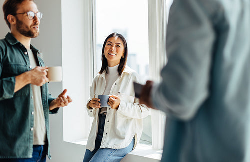 Young business professionals having a coffee break in an office