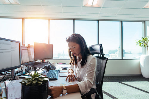 Woman entrepreneur at work in office.