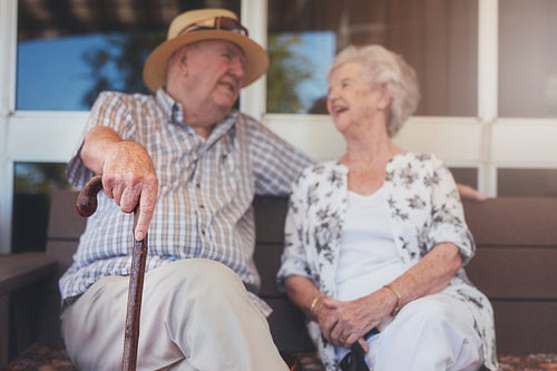Loving elderly couple relaxing outdoors on a bench