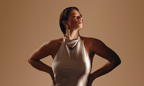 Confident woman in satin top enjoying a wellness moment