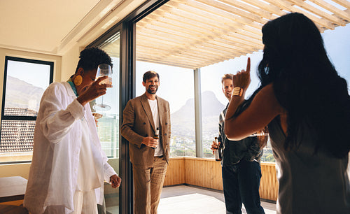 Friends enjoying a weekend gathering in a stylish home with mountain views