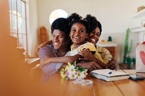 A joyful celebration of love and family: Mother and children sharing smiles, hugs, and flowers