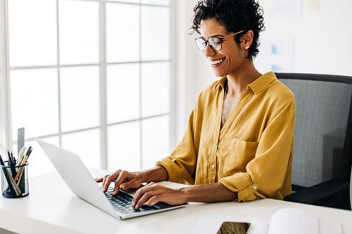 Business woman typing on a laptop