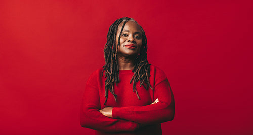 Confident black woman looking at the camera in a studio