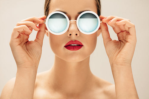 Young woman in sunglasses and red lips