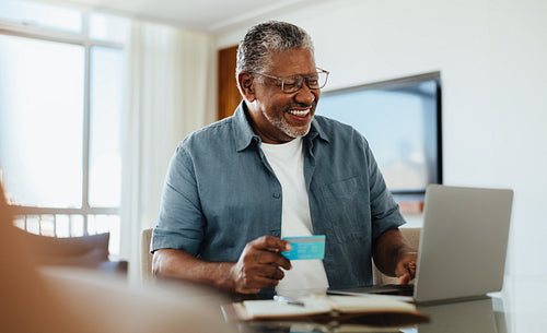 Elderly E-Commerce: Happy older man shopping online.