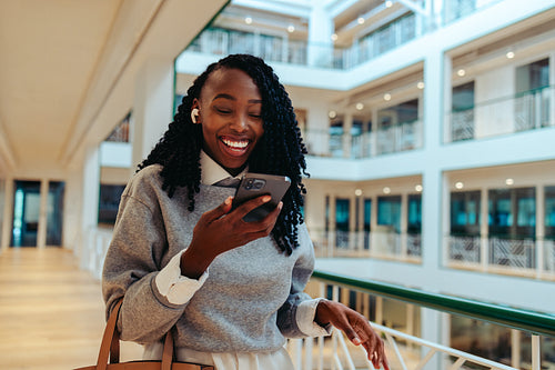 Happy corporate employee using smartphone