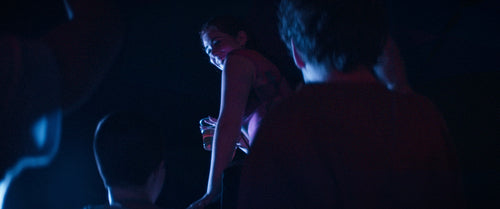 Energetic woman on shoulders at a concert