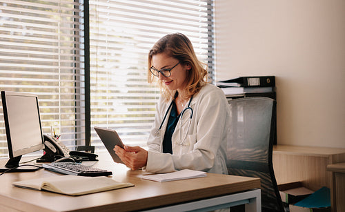 Female doctor working on her tablet pc