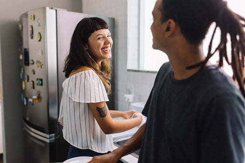 Happy couple doing kitchen chores together