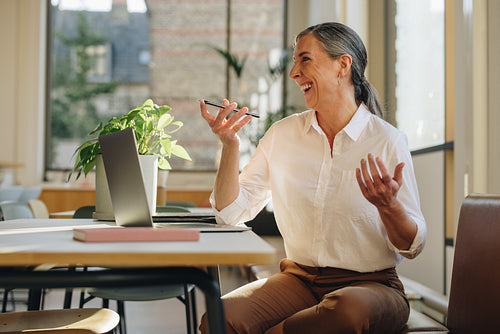Happy freelancer speaking on smart phone