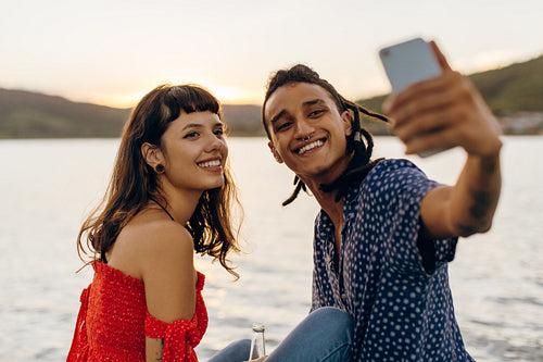 Happy young couple taking selfies while on a vacation