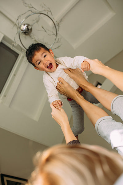 Mother and son enjoying a morning in a bedroom