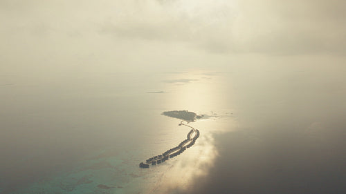 Captivating drone shot of a luxurious tropical island resort with overwater bungalows