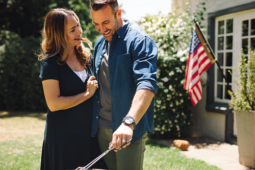 Smiling man and woman making food celebrating an occasion