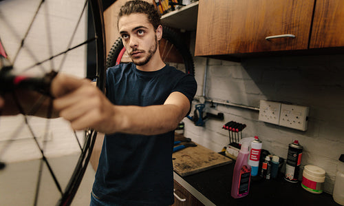 Mechanic repairing a bicycle in workshop