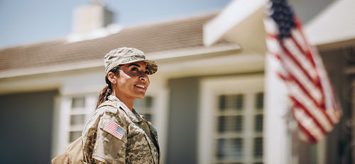 Happy female soldier returning home from the military