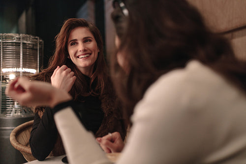 Female friends talking at a coffee shop