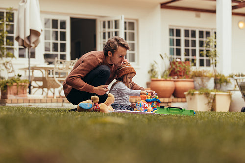 Father and daughter playing in their backyard