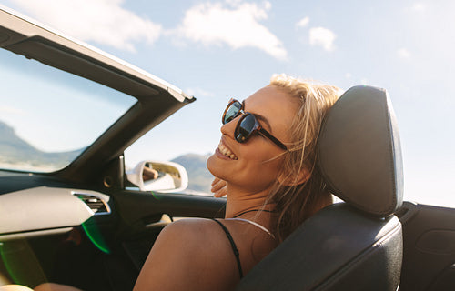 Woman traveling by a car on road trip