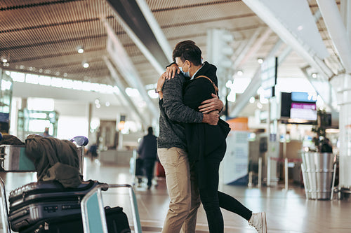 Woman hugging man after arrival from trip