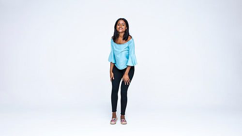 Young woman standing against white background