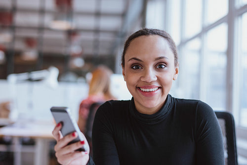 African woman at work looking at camera smiling