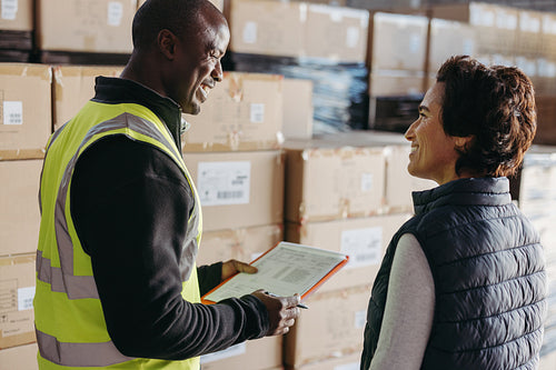 Happy logistics worker delivering goods to a warehouse