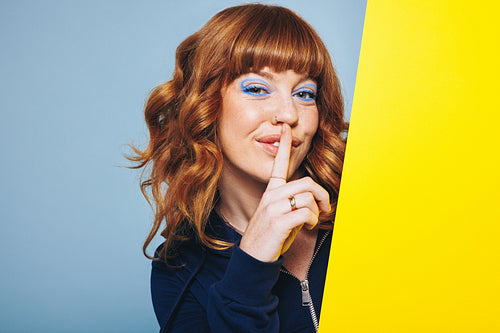 Woman making a hush gesture in a design studio