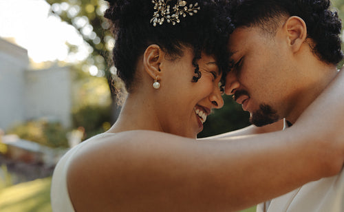 Loving couple sharing an emotional moment on their wedding day