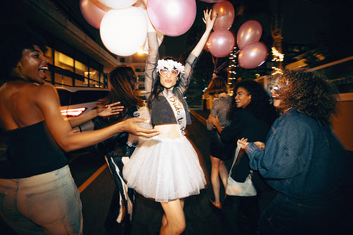 Group of young women celebrating a bachelorette party during a fun night out