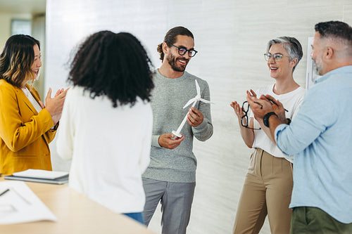 Happy design professionals applauding during a meeting