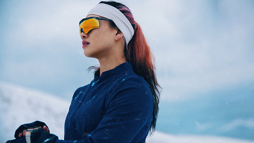 Sportswear on a woman in winter snow creates a focused outdoor portrait