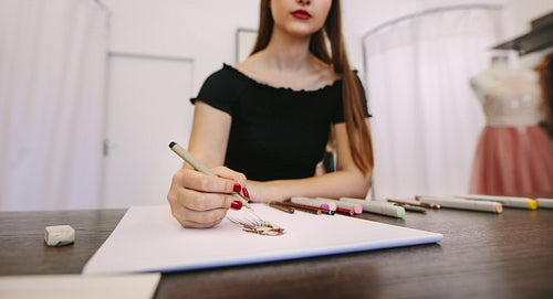 Fashion designer working on her designs in her studio