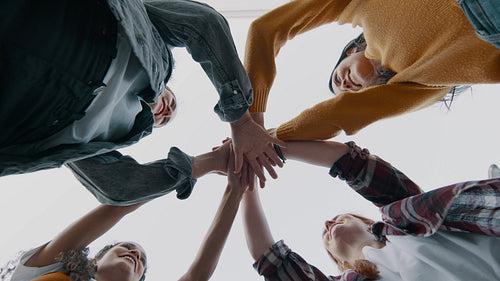Female friends stacking hands