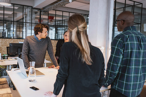 Team of young designers working together in office