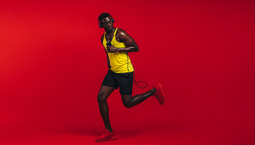 Muscular man exercising in studio