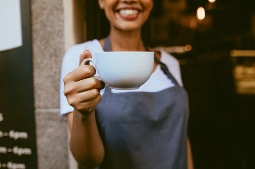 Barista offering a coffee