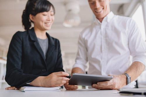 Businesspeople using digital tablet in office