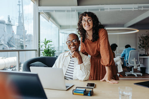 Successful collaboration between diverse business women in a modern boardroom