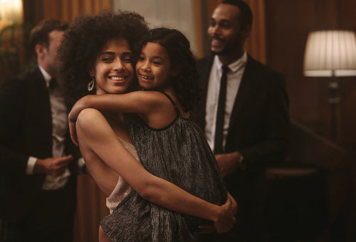 Happy mother and daughter at a party
