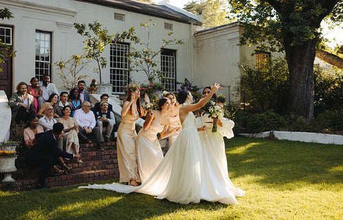 Wedding guests enjoying a garden celebration with two brides