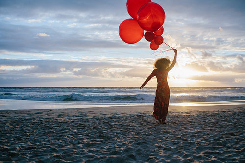 Woman on the beach with balloons
